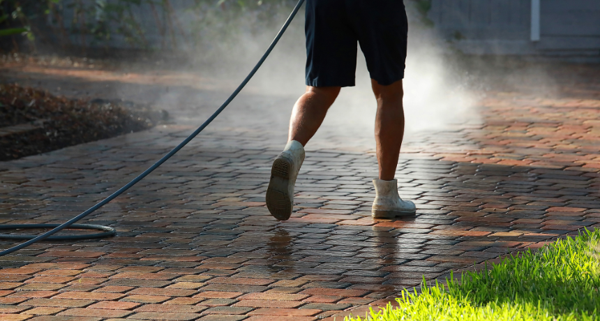 Worker Cleaning Pavers