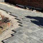 Installing patio pavers by the Pavestone Brick Paving team horizontal