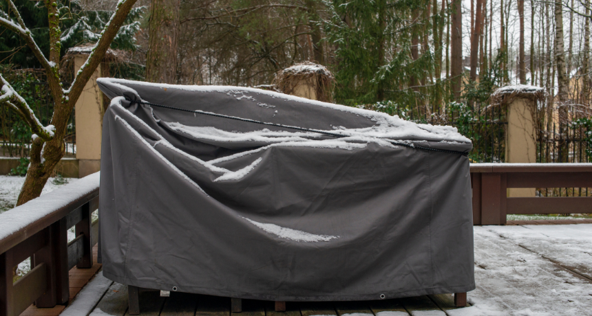 Patio furniture Cover protecting outdoor furniture from snow.